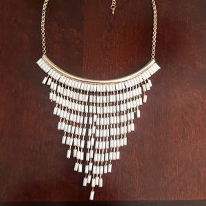 White and gold women’s necklace.